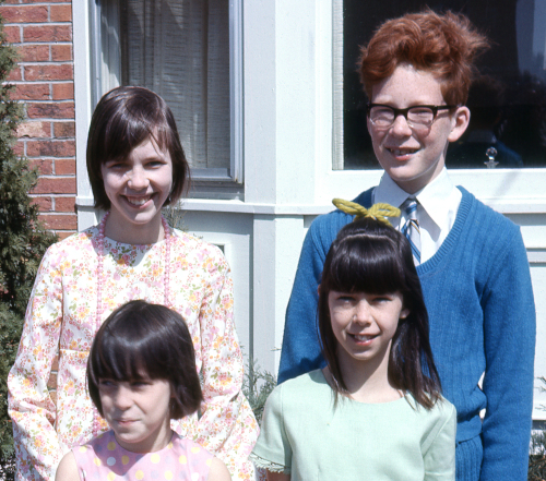 Three girls in 1970s Easter clothes, one boy with red hair